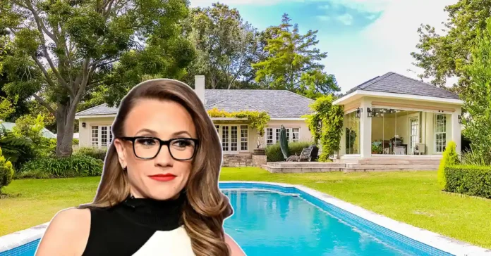 Kat Timpf house living room with charcoal gray sectional and white walls in Manhattan apartment