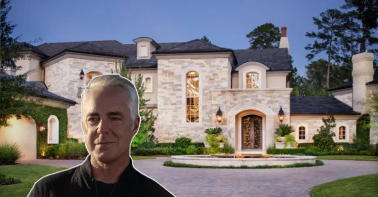 Aerial view of the Harry Bosch house cantilevered over Hollywood Hills, showcasing its modern wood-and-glass design against LA skyline at dusk.