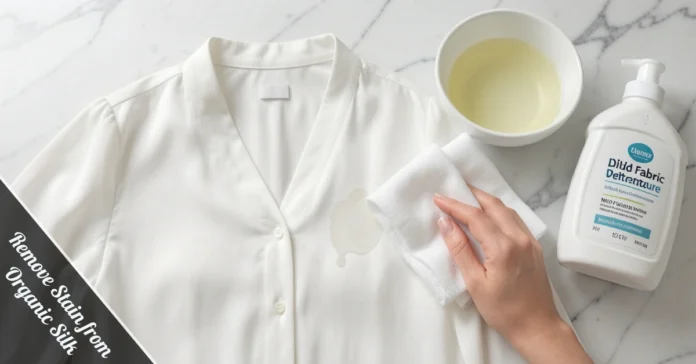 Remove stains from organic silk blouse using white cloth and mild detergent on marble surface in natural light.