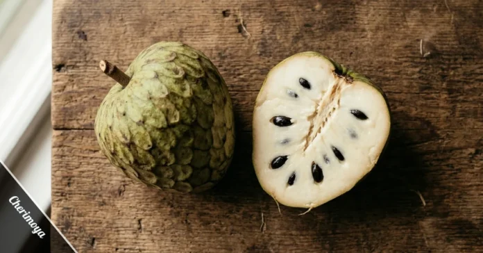 Ripe cherimoya fruit cut in half showing creamy white flesh and black seeds
