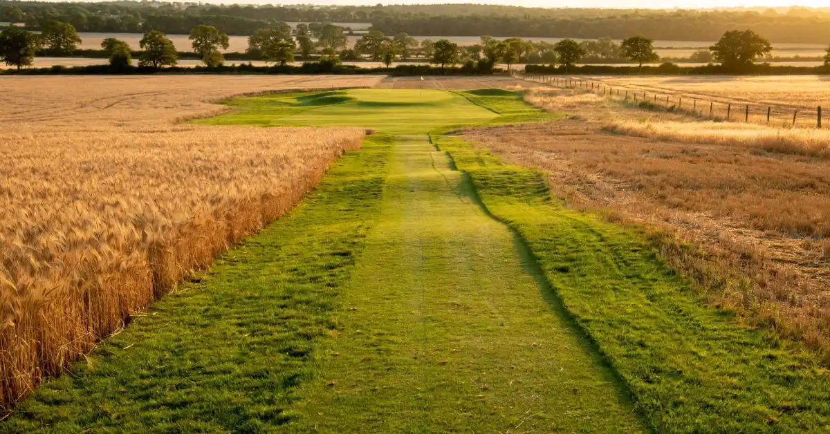 Private mown golf course fairway and green set on open farmland